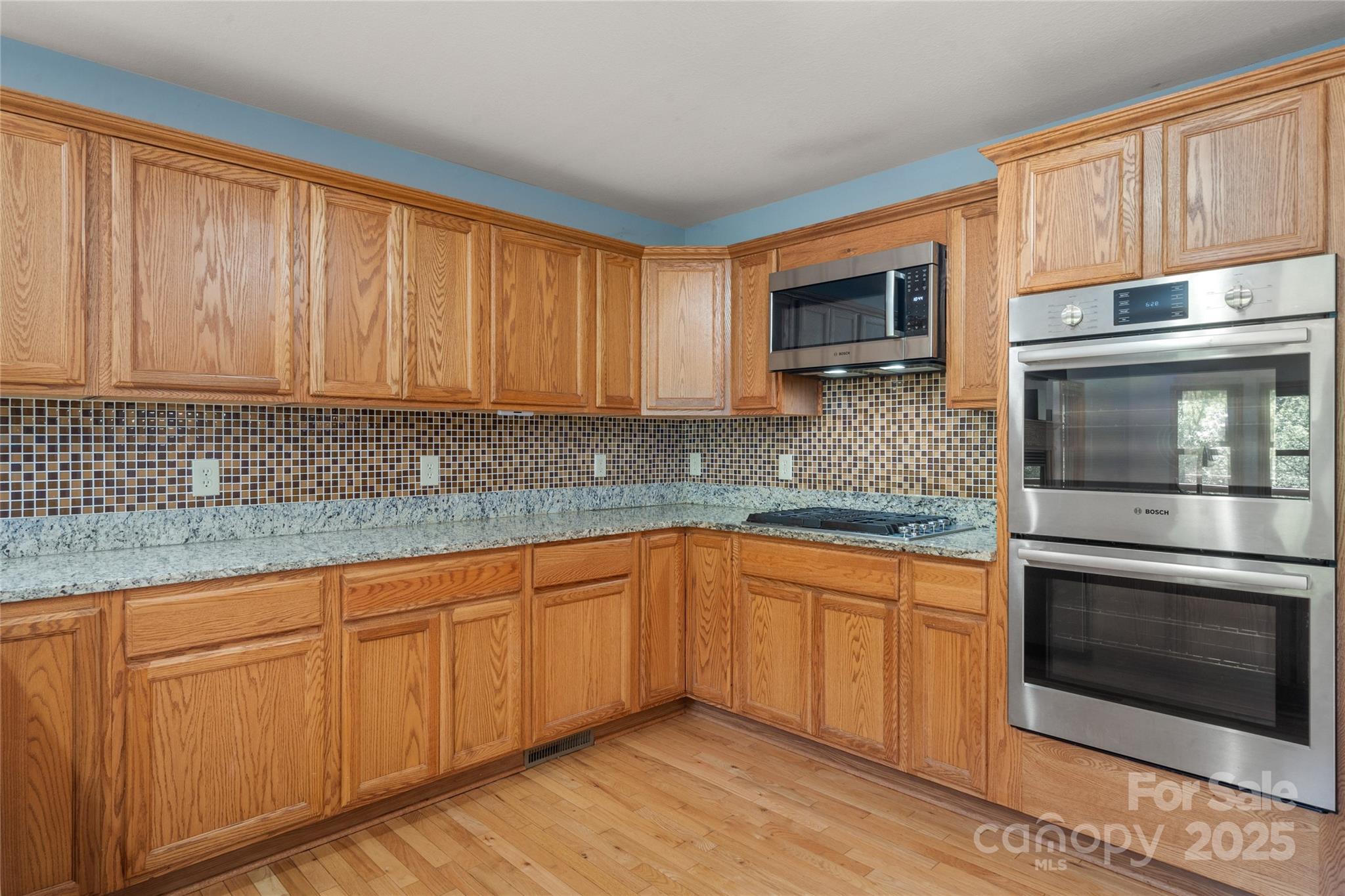 234 Deer Run Road Canton, NC 28716 - Photo 21 of 48 a kitchen with stainless steel appliances granite countertop a stove a sink and a microwave