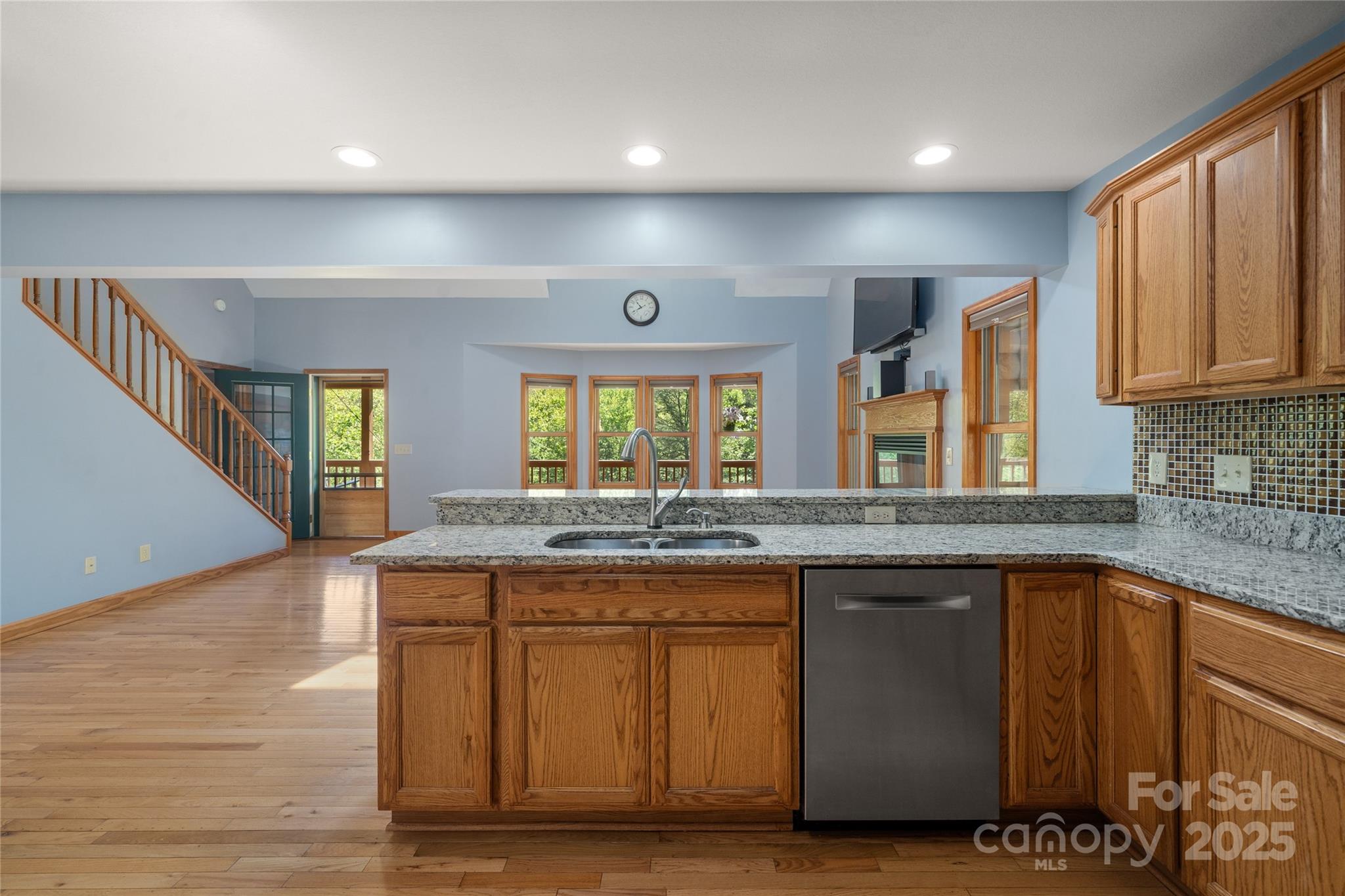234 Deer Run Road Canton, NC 28716 - Photo 23 of 48 a kitchen with kitchen island granite countertop wooden cabinets and a sink