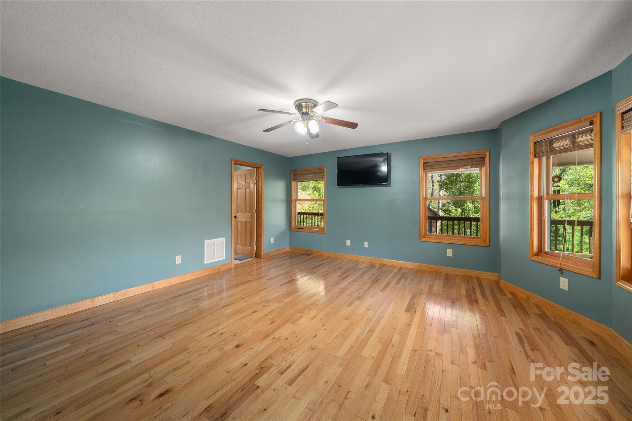 234 Deer Run Road Canton, NC 28716 - Photo 26 of 48 a view of an empty room with a window and wooden floor