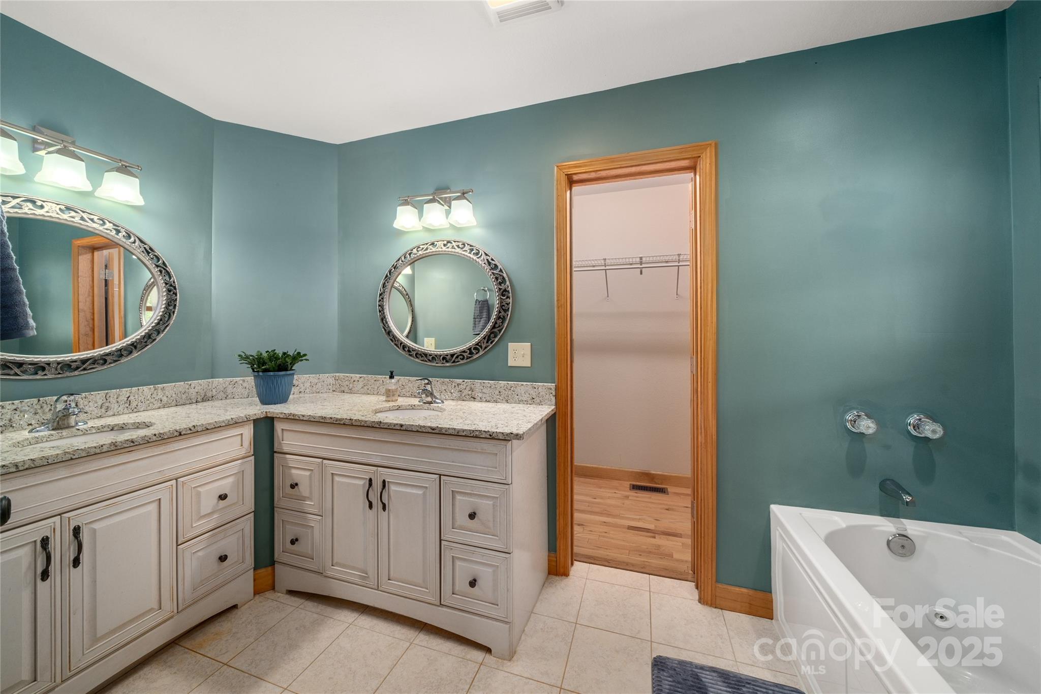 234 Deer Run Road Canton, NC 28716 - Photo 28 of 48 a bathroom with a granite countertop sink a mirror a vanity and a bathtub