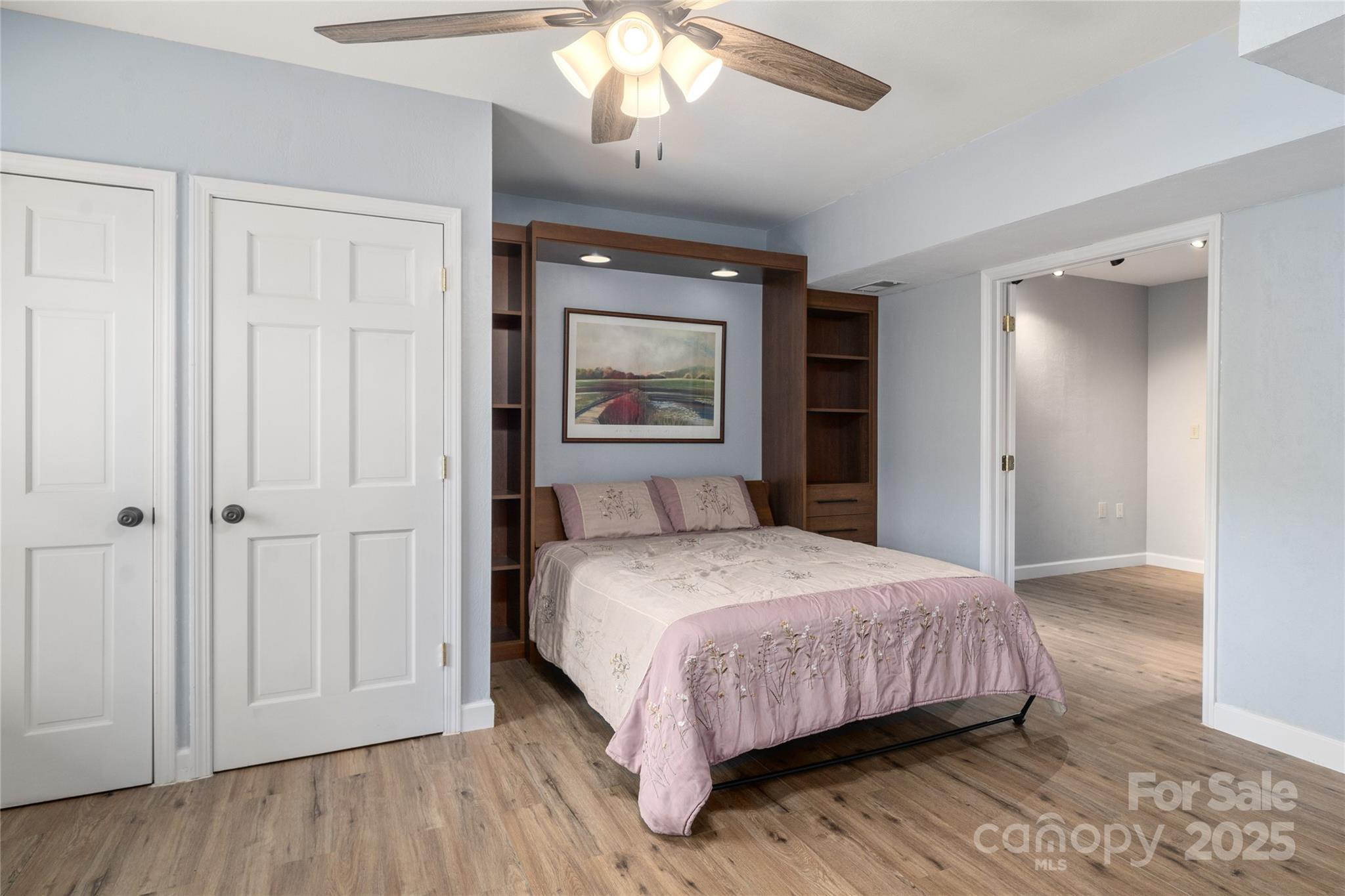 234 Deer Run Road Canton, NC 28716 - Photo 38 of 48 a bedroom with a large bed and a chandelier