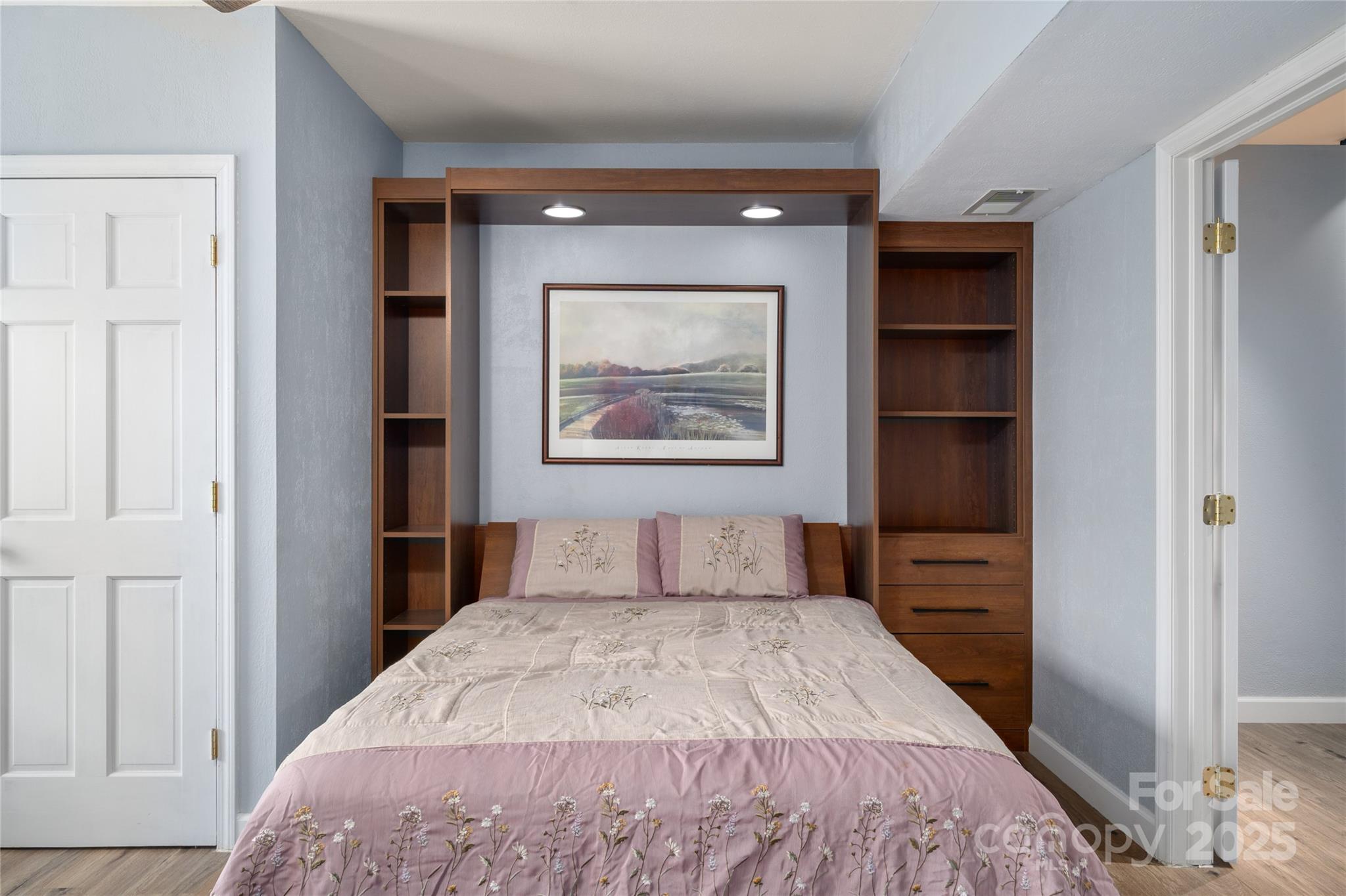 234 Deer Run Road Canton, NC 28716 - Photo 39 of 48 a bedroom with a bed and a painting on the wall