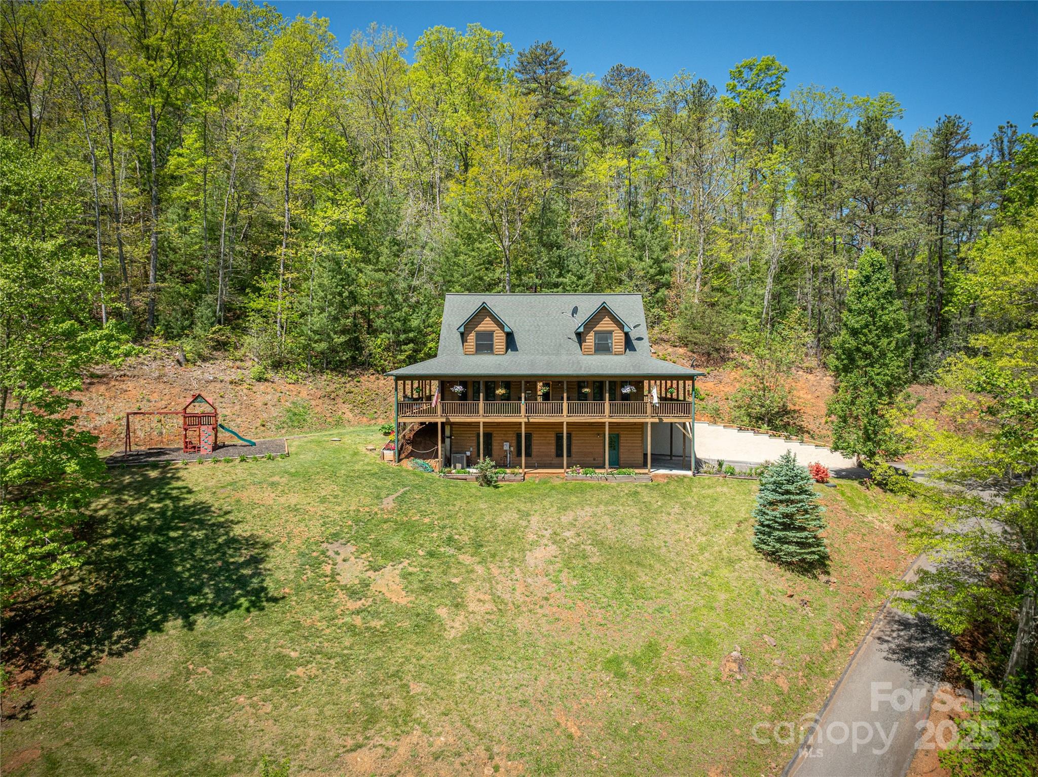 234 Deer Run Road Canton, NC 28716 - Photo 4 of 48 a view of a house with a big yard and large trees