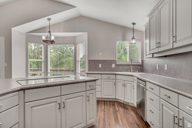 2154 Wasatch Boulevard Sandy, UT 84092 - Photo 26 of 55 Kitchen with pendant lighting, dark wood-style flooring, light countertops, tasteful backsplash, and vaulted ceiling
