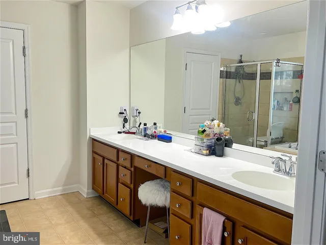 a bathroom with a double vanity sink and a mirror