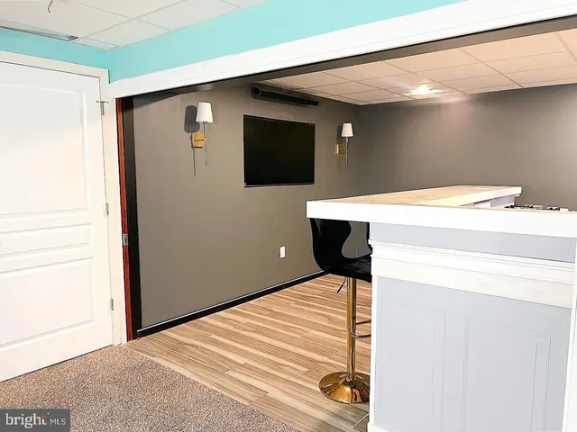 a living room with furniture and a ceiling fan