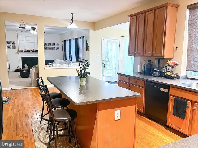 a kitchen with a table chairs refrigerator and cabinets