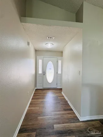a view of a room with wooden floor