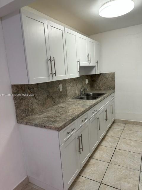 Miami Lakes Miami Lakes, FL 33014 - Photo 2 of 8 a kitchen with granite countertop a sink and cabinets