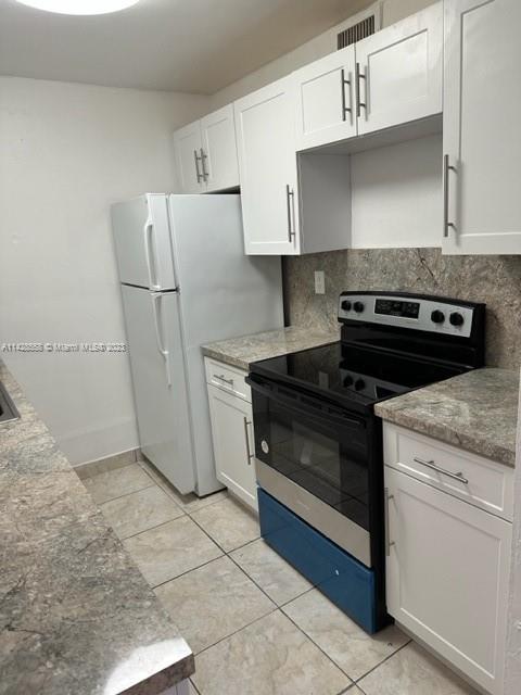 Miami Lakes Miami Lakes, FL 33014 - Photo 4 of 8 a kitchen with granite countertop white cabinets and white appliances