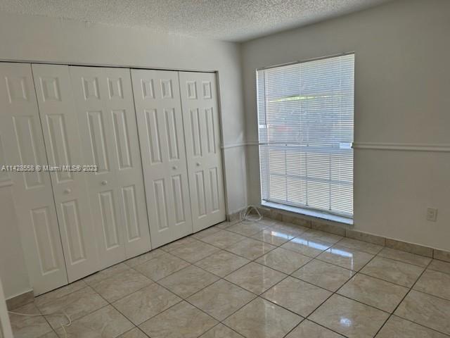 Miami Lakes Miami Lakes, FL 33014 - Photo 6 of 8 an empty room with sliding door