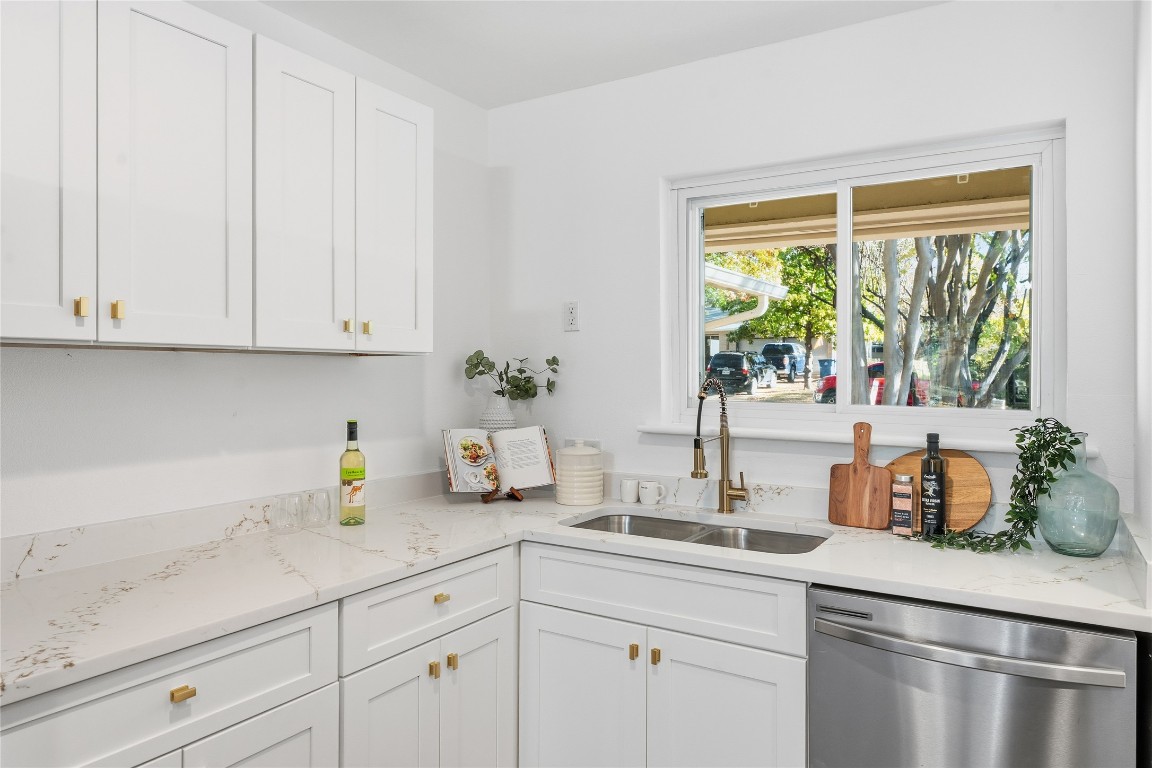 6710 Kings Point West Austin, TX 78723 - Photo 15 of 40 a kitchen with stainless steel appliances white cabinets and a window