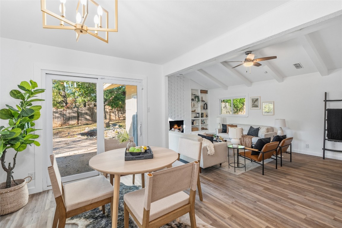 6710 Kings Point West Austin, TX 78723 - Photo 18 of 40 a view of a dining room with furniture window and wooden floor