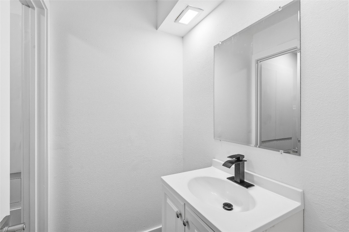 6710 Kings Point West Austin, TX 78723 - Photo 22 of 40 a bathroom with a sink and a mirror