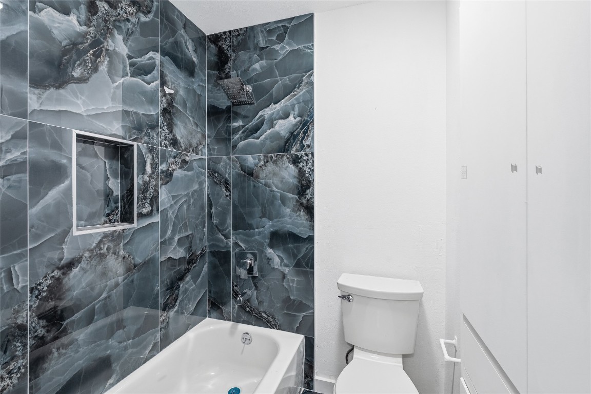 6710 Kings Point West Austin, TX 78723 - Photo 23 of 40 a bathroom with a toilet and a shower