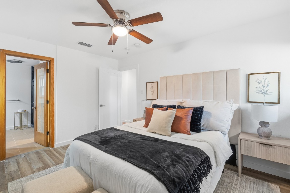 6710 Kings Point West Austin, TX 78723 - Photo 25 of 40 a bedroom with a large bed and a couch