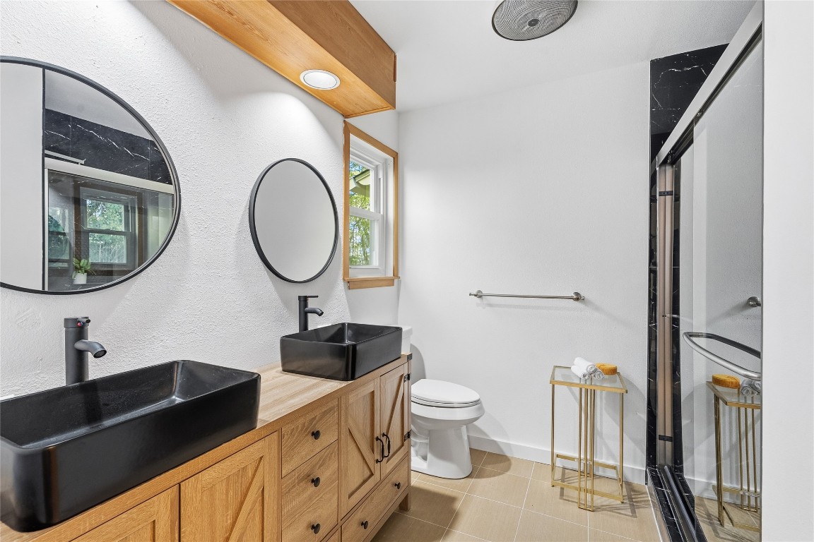 6710 Kings Point West Austin, TX 78723 - Photo 26 of 40 a bathroom with a sink and a mirror