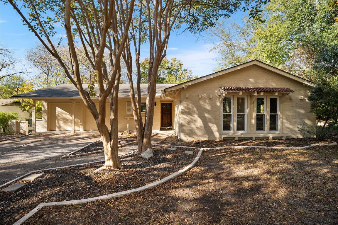 6710 Kings Point West Austin, TX 78723 - Photo 3 of 40 a front view of a house with a yard