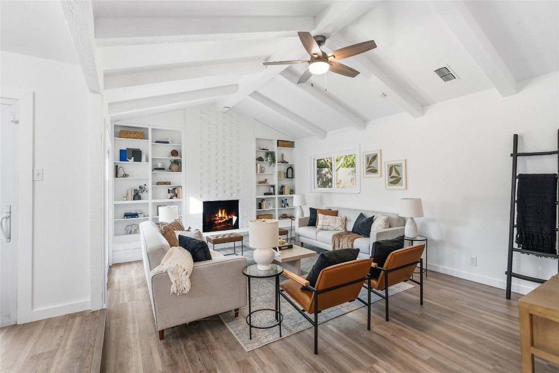 6710 Kings Point West Austin, TX 78723 - Photo 6 of 40 a living room with furniture a fireplace and a flat screen tv