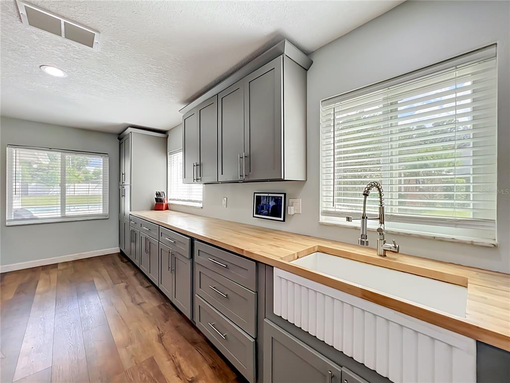 153 Variety Tree Circle Altamonte Springs, FL 32714 - Photo 10 of 44 a kitchen with wooden floors and sink