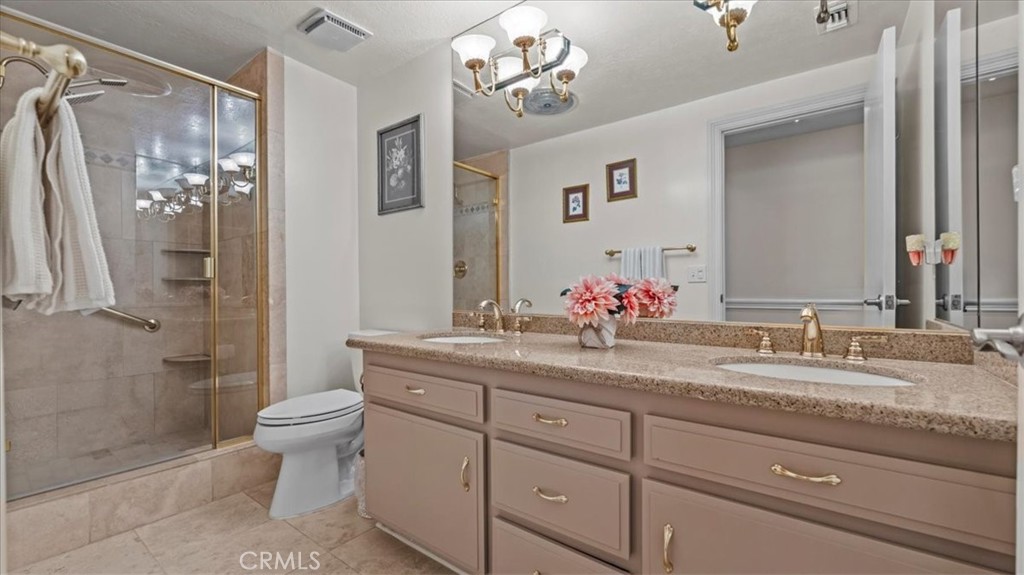 1958 Canyon Close Road Pasadena, CA 91107 - Photo 15 of 40 a bathroom with a granite countertop sink toilet a large mirror a shower and vanity