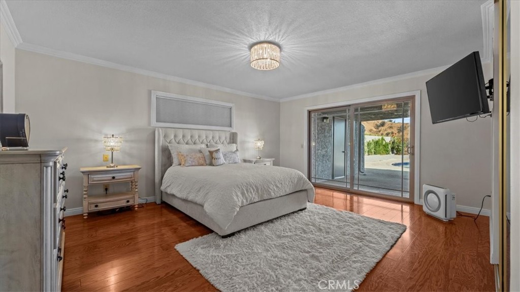 1958 Canyon Close Road Pasadena, CA 91107 - Photo 16 of 40 a bedroom with a bed and wooden floor