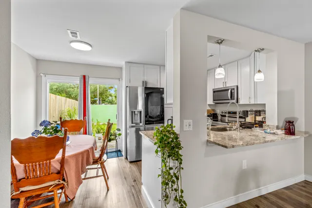 a dining room with furniture and a large window