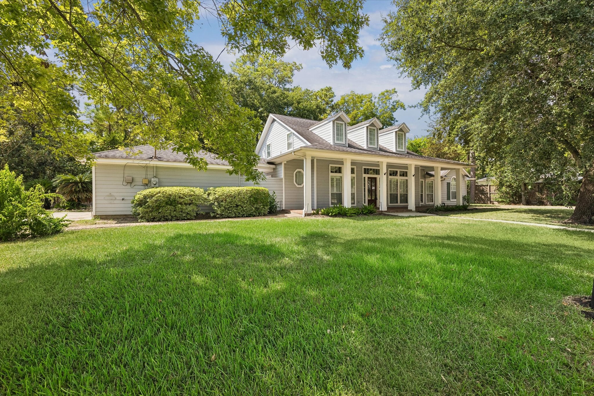 1203 Bingle Road Houston, TX 77055 - Photo 2 of 21 Charming home with a welcoming front porch and large windows, nestled under the shade of a mature tree, offering a perfect blend of elegance and tranquility.