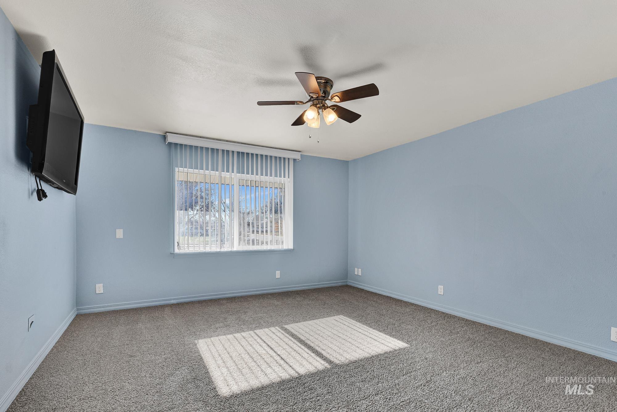 901 East 2nd Street South Middleton, ID 83644 - Photo 14 of 50 Primary Bedroom Suite featuring new light carpet huge windows and ceiling fan