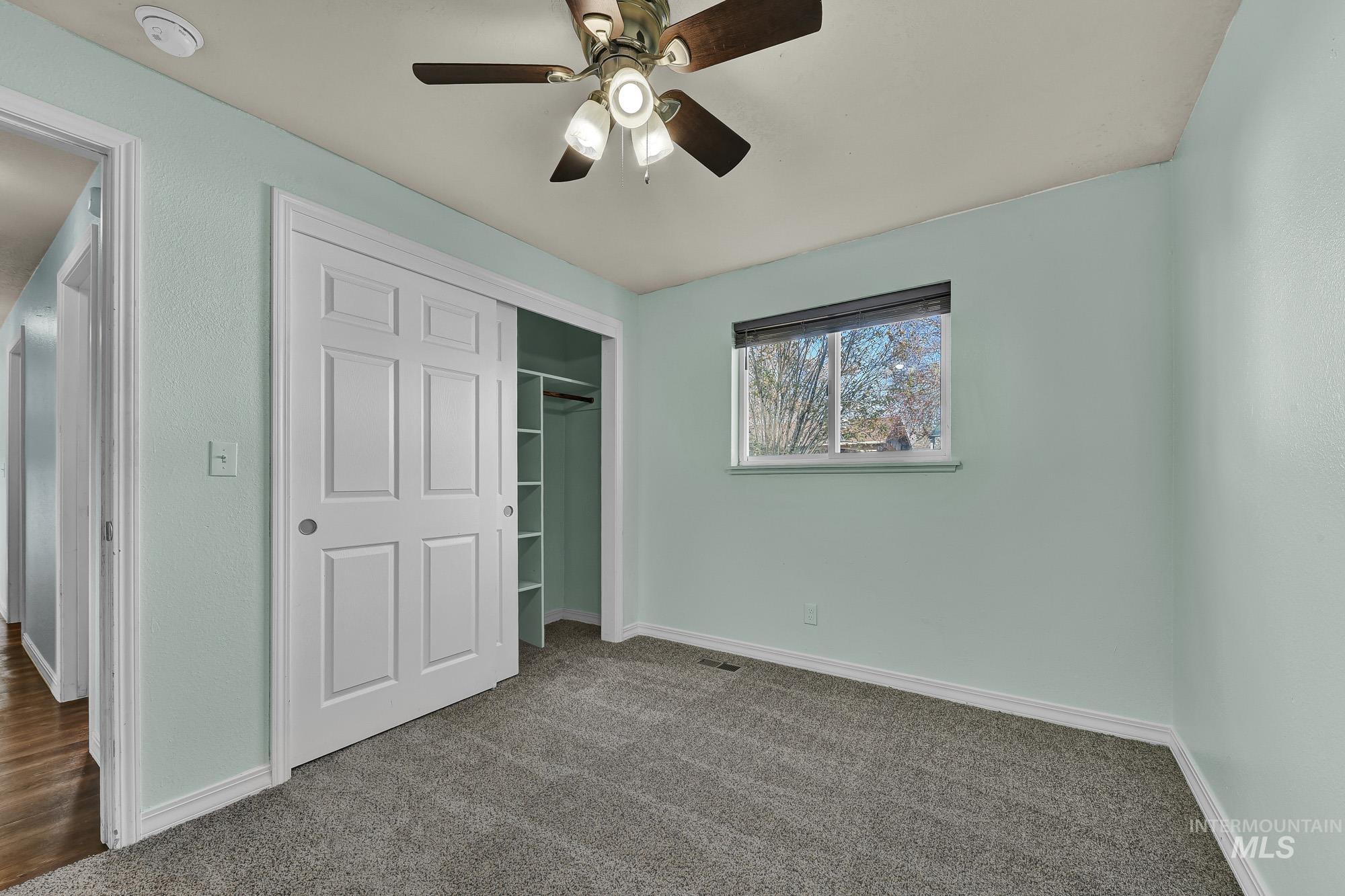 901 East 2nd Street South Middleton, ID 83644 - Photo 20 of 50 Unfurnished bedroom with new carpet, a closet, and ceiling fan
