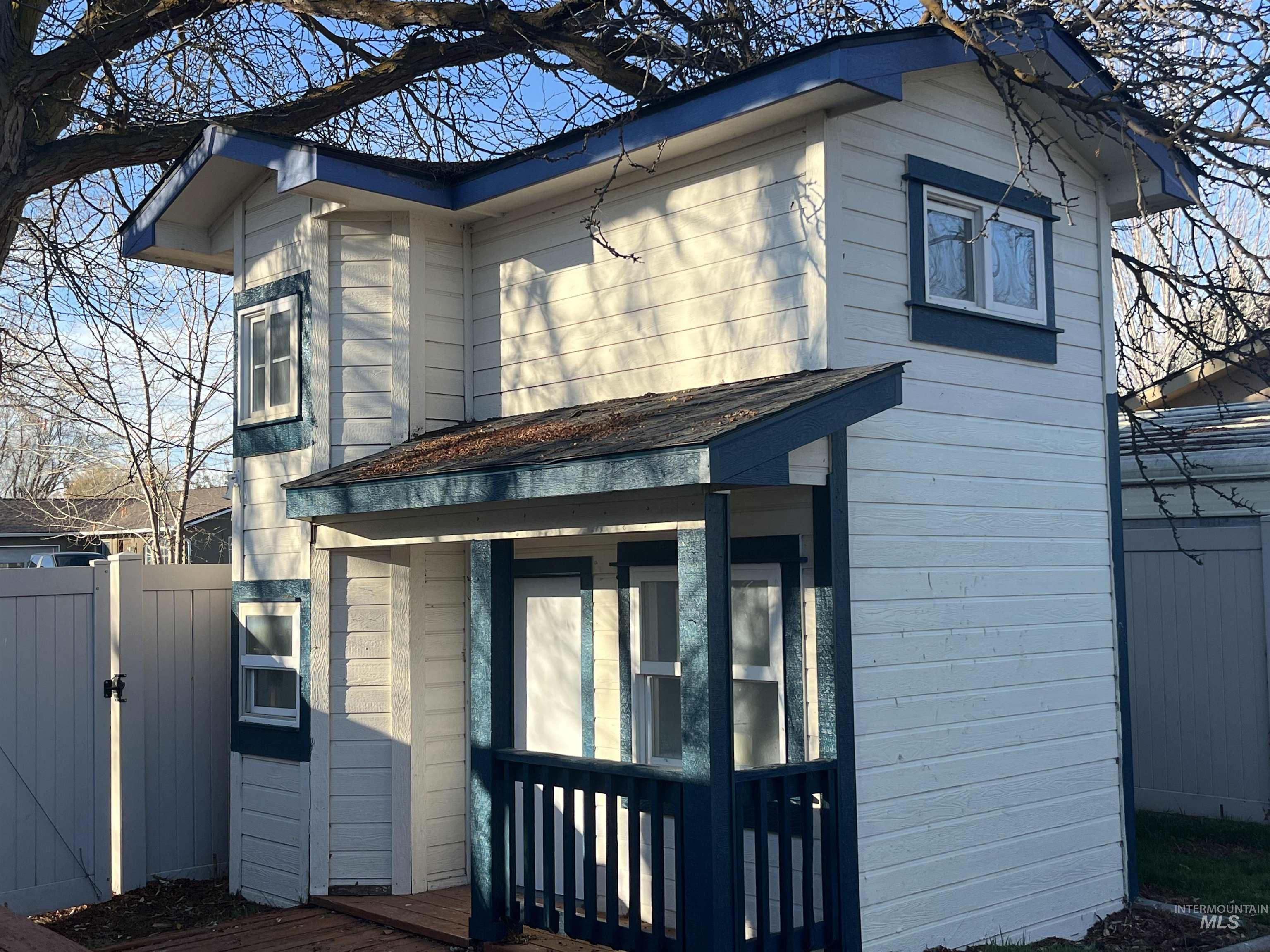 901 East 2nd Street South Middleton, ID 83644 - Photo 27 of 50 Side view of 2 story play house with a gate and a shingled roof
