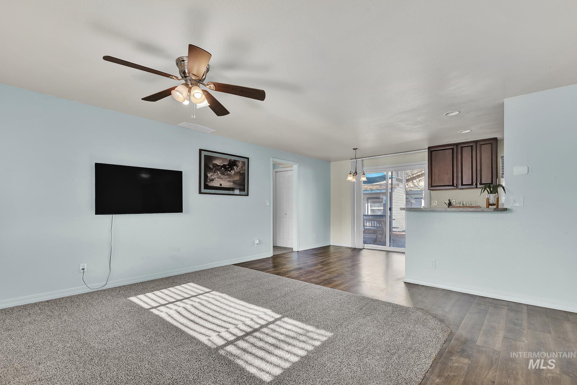 901 East 2nd Street South Middleton, ID 83644 - Photo 6 of 50 Unfurnished living room featuring new carpet - a ceiling fan, and laminate wood-like floors