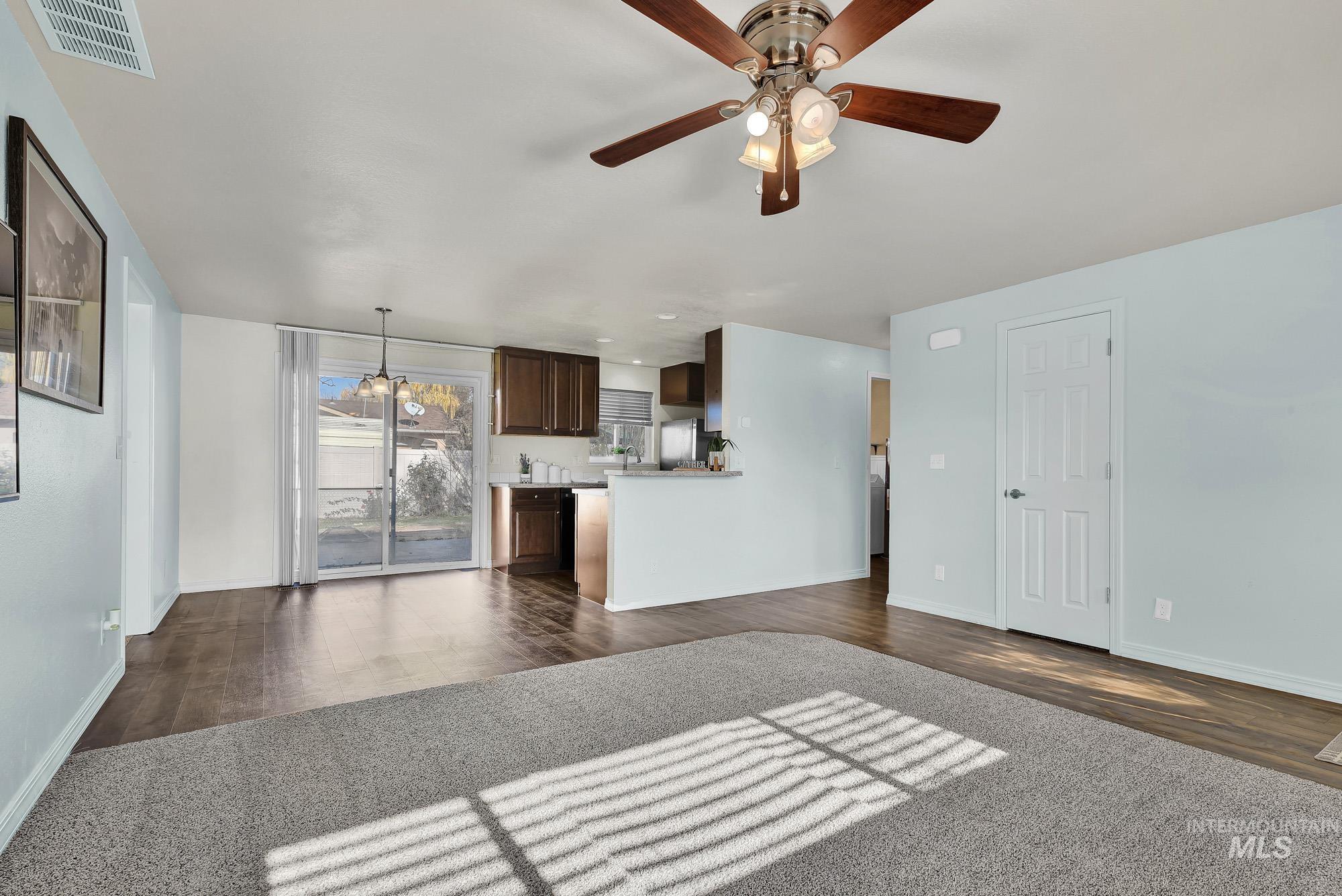 901 East 2nd Street South Middleton, ID 83644 - Photo 7 of 50 Newly carpeted living room featuring a ceiling fan and laminate wood like finished floors