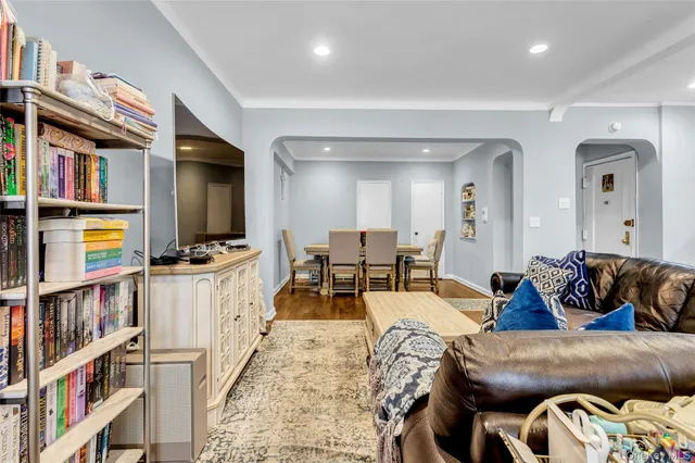 a living room with furniture and a book shelf