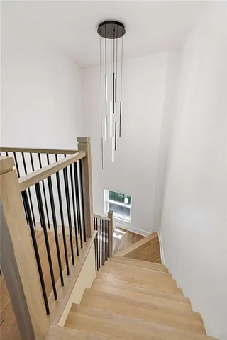 a view of a hallway with wooden floor and staircase