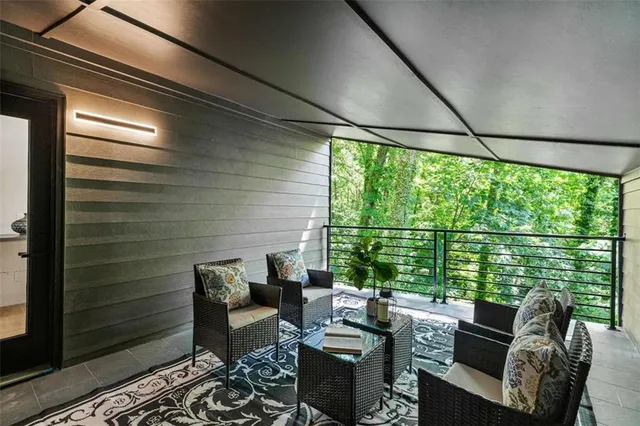 a living room with furniture and floor to ceiling windows