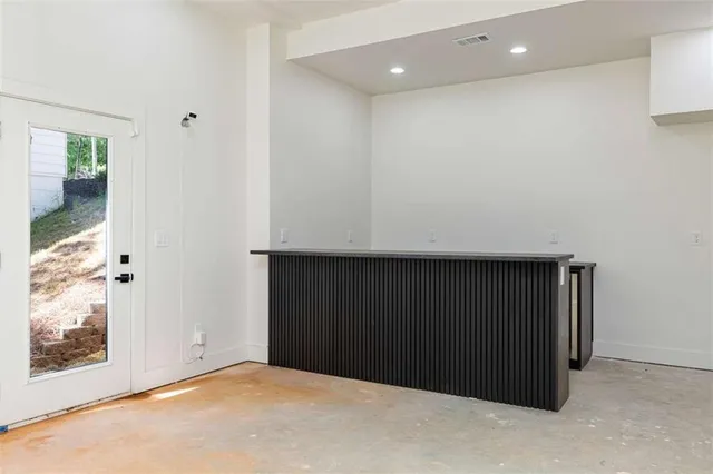 a backyard of a house with large trees and a barn