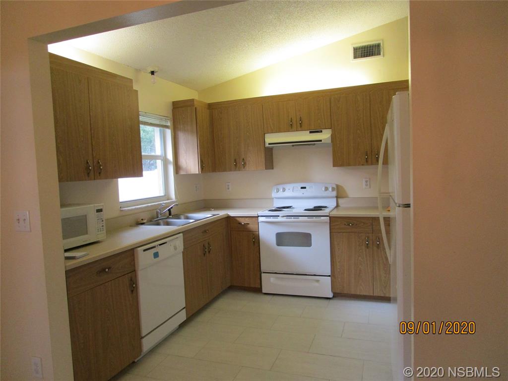 508 Sandpiper Court Edgewater, FL 32141 - Photo 5 of 10 a kitchen with a sink stove and cabinets