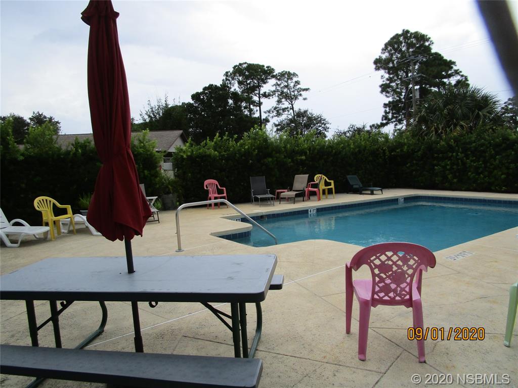 508 Sandpiper Court Edgewater, FL 32141 - Photo 10 of 10 a table and chairs in front of a yard