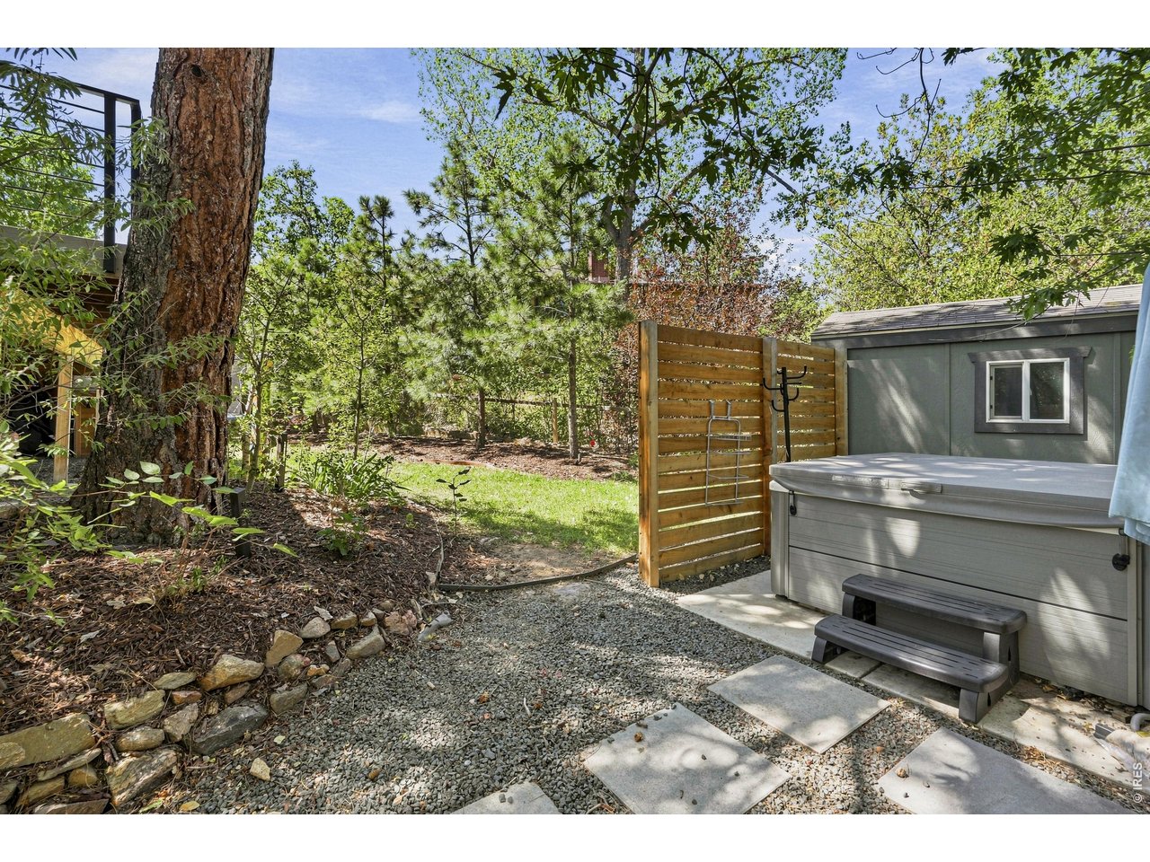 1964 Foothills Road Golden, CO 80401 - Photo 35 of 50 Hot tub set inside a private fenced area, framed by mature trees.
