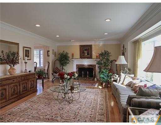 14 Golf Road Edison, NJ 08820 - Photo 2 of 20 a living room with furniture a fireplace and a large window