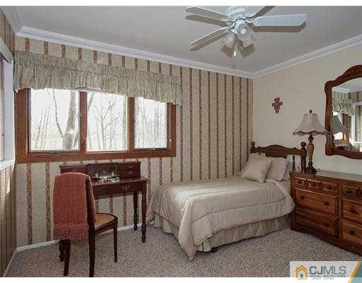 14 Golf Road Edison, NJ 08820 - Photo 11 of 20 a bedroom with a bed a table and chair