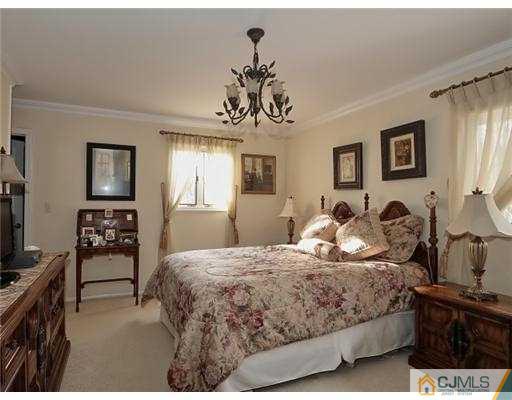 14 Golf Road Edison, NJ 08820 - Photo 13 of 20 a bedroom with a bed and wooden floor