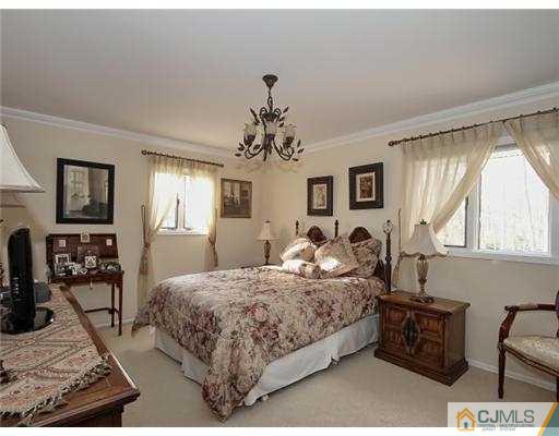 14 Golf Road Edison, NJ 08820 - Photo 20 of 20 a bedroom with a balcony a bed and dresser with mirror