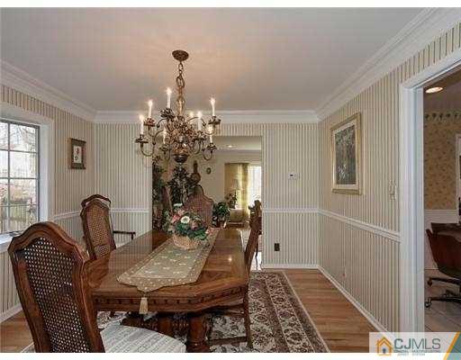 14 Golf Road Edison, NJ 08820 - Photo 5 of 20 a living room with furniture and a chandelier