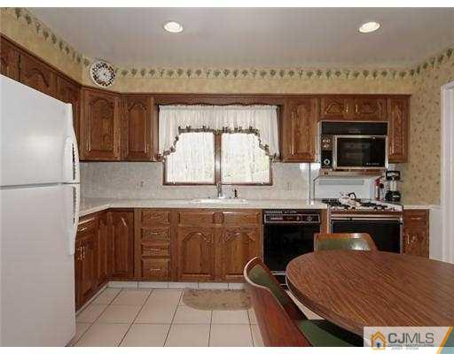 14 Golf Road Edison, NJ 08820 - Photo 7 of 20 a kitchen with a sink a stove and a refrigerator