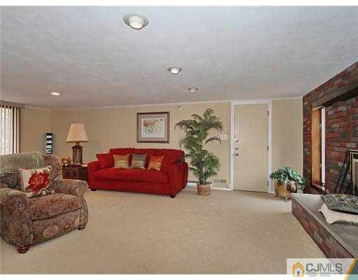14 Golf Road Edison, NJ 08820 - Photo 8 of 20 a spacious bedroom with a bed and a couch