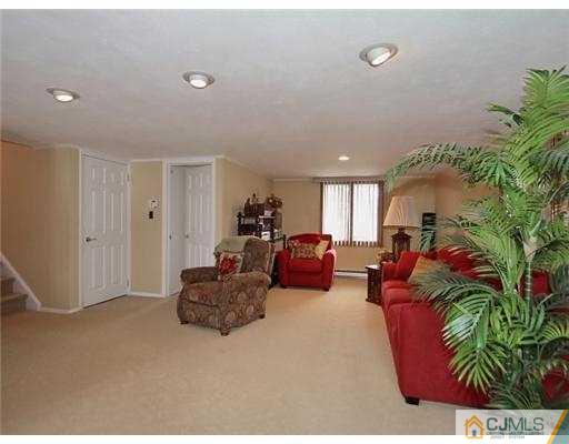 14 Golf Road Edison, NJ 08820 - Photo 9 of 20 a living room with furniture and a potted plant
