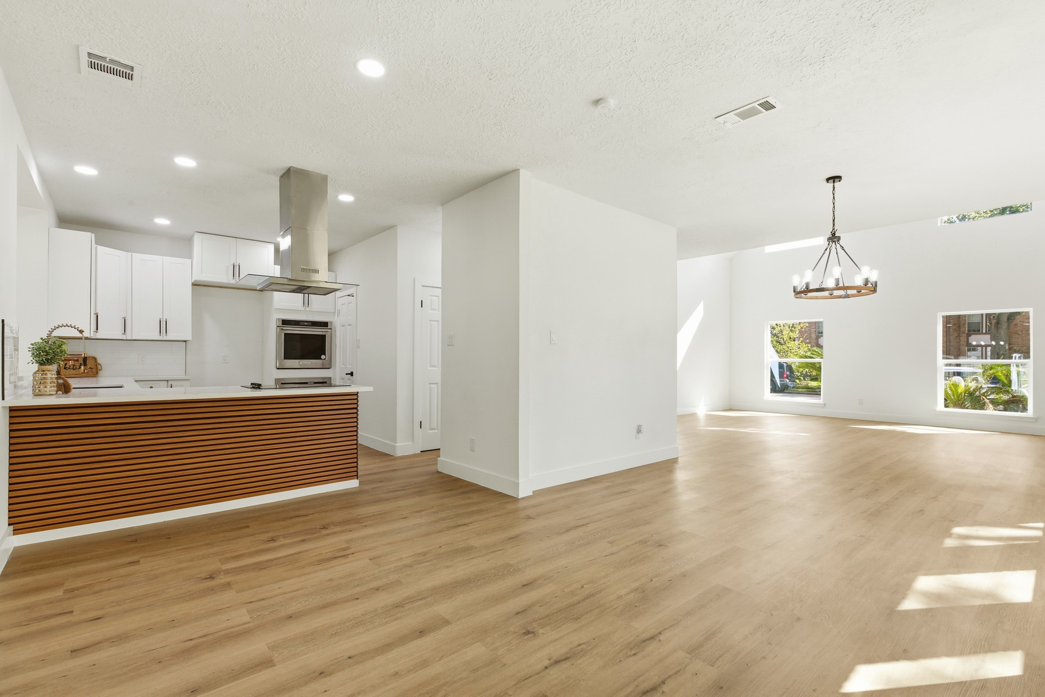 7338 San Ramon Drive Houston, TX 77083 - Photo 15 of 38 a view of a kitchen with kitchen island wooden floor stainless steel appliances and cabinets
