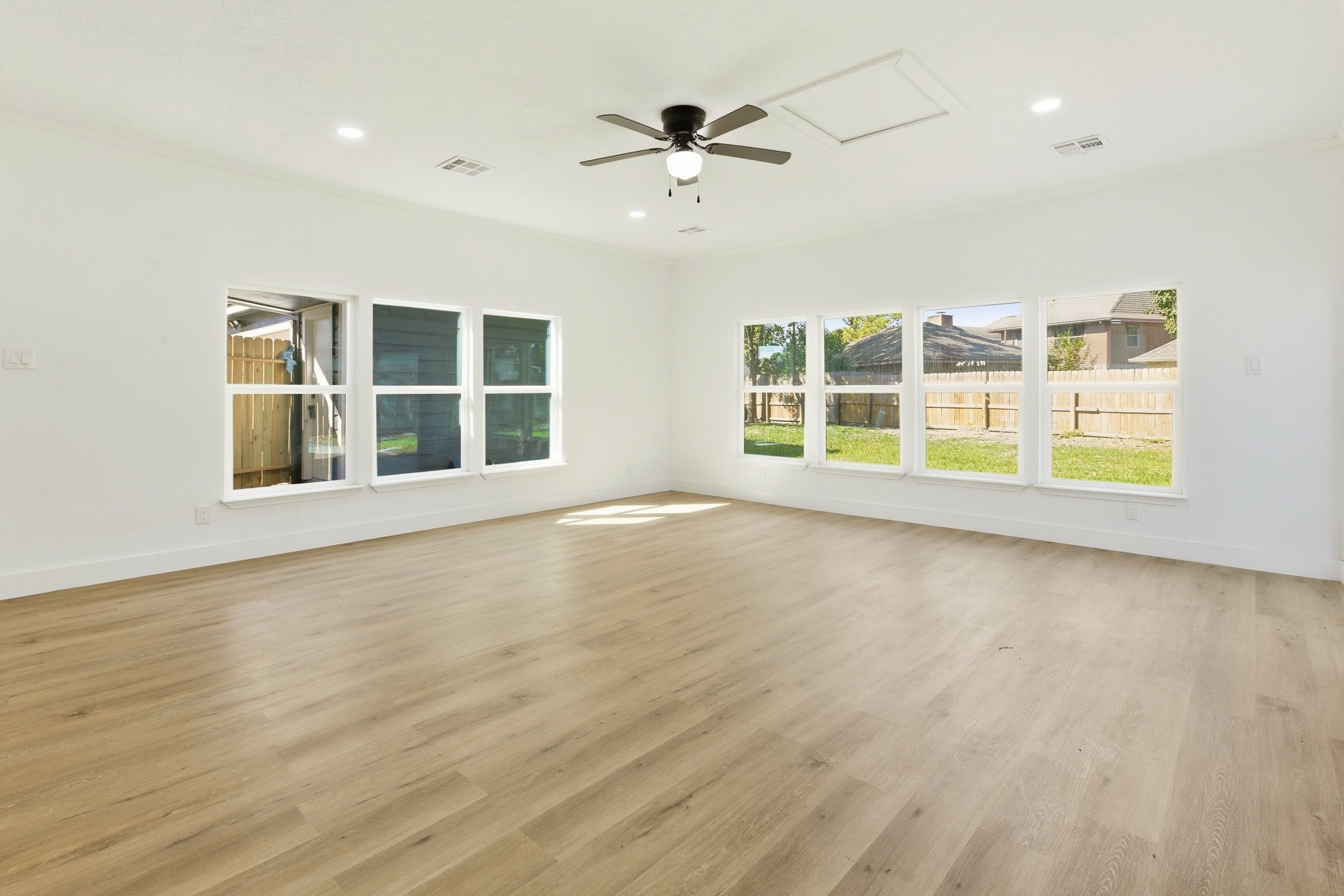 7338 San Ramon Drive Houston, TX 77083 - Photo 18 of 38 an empty room with wooden floor and windows